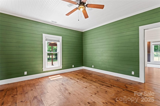 233 Sellars Rd, Kings Mountain, NC 28086 - empty room with hardwood / wood-style flooring, ceiling fan, wooden walls, and baseboards