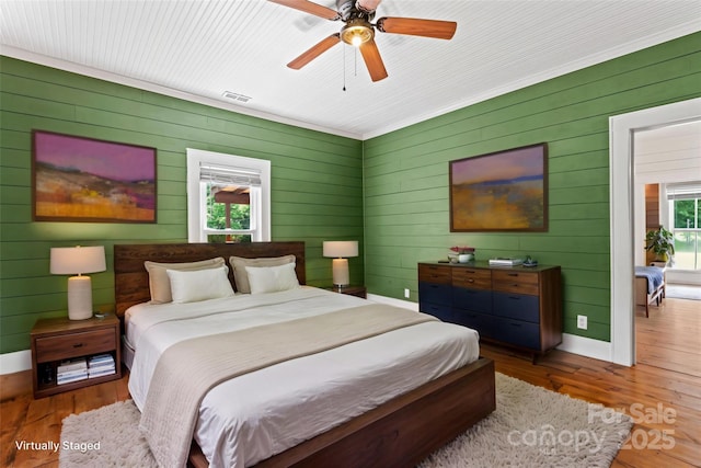 233 Sellars Rd, Kings Mountain, NC 28086 - bedroom with wood walls, wood finished floors, baseboards, and a ceiling fan