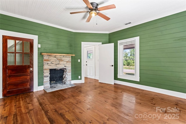 233 Sellars Rd, Kings Mountain, NC 28086 - unfurnished living room featuring crown molding, a fireplace, ceiling fan, wood walls, and wood-type flooring