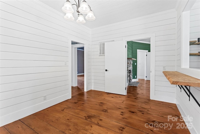 233 Sellars Rd, Kings Mountain, NC 28086 - unfurnished dining area featuring a chandelier, crown molding, hardwood / wood-style floors, and wood walls
