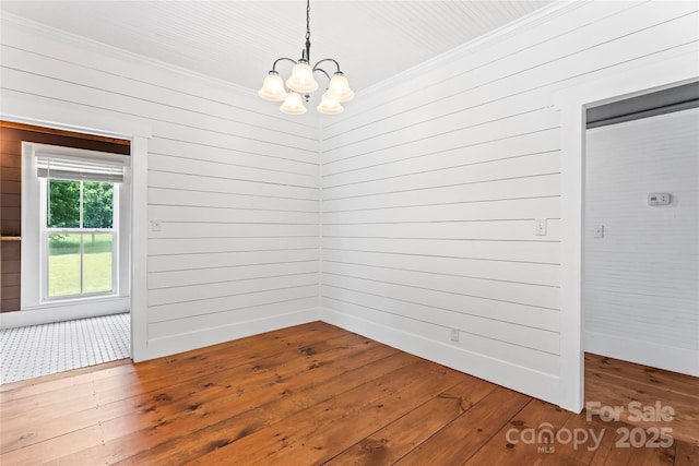 233 Sellars Rd, Kings Mountain, NC 28086 - spare room featuring crown molding, a chandelier, hardwood / wood-style flooring, and wooden walls