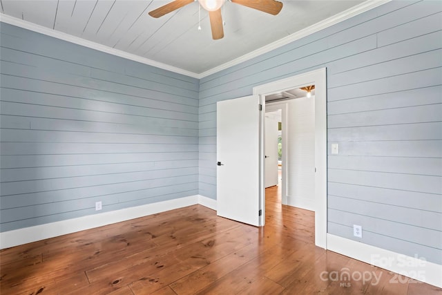 233 Sellars Rd, Kings Mountain, NC 28086 - empty room with hardwood / wood-style floors, crown molding, a ceiling fan, wood walls, and baseboards
