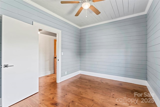 233 Sellars Rd, Kings Mountain, NC 28086 - empty room with ornamental molding, light wood-style flooring, ceiling fan, and wood walls