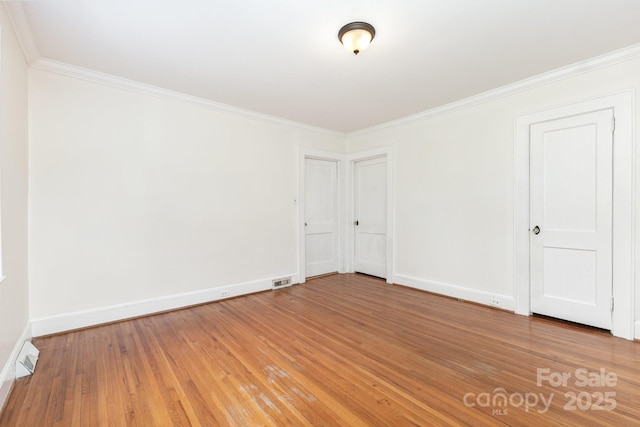 1400 Matheson Ave, Charlotte, NC 28205 - unfurnished bedroom featuring ornamental molding, light wood-type flooring, and baseboards