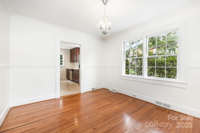 1400 Matheson Ave, Charlotte, NC 28205 - unfurnished room with a chandelier, light wood finished floors, ornamental molding, and baseboards