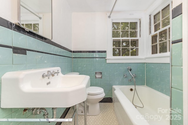 1400 Matheson Ave, Charlotte, NC 28205 - bathroom featuring a bath, toilet, a sink, tile walls, and wainscoting