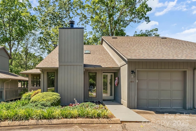 903 Independence Trl, Morganton, NC 28655 - view of front of home featuring roof with shingles, a chimney, and an attached garage