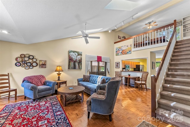 903 Independence Trl, Morganton, NC 28655 - living area featuring vaulted ceiling, a ceiling fan, a skylight, healthy amount of natural light, and rail lighting