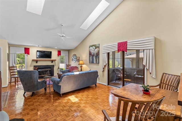 903 Independence Trl, Morganton, NC 28655 - living room featuring a skylight, a glass covered fireplace, a ceiling fan, high vaulted ceiling, and baseboards