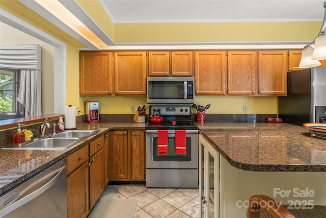 903 Independence Trl, Morganton, NC 28655 - kitchen with appliances with stainless steel finishes, a sink, brown cabinetry, and a peninsula