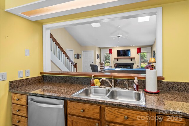 903 Independence Trl, Morganton, NC 28655 - kitchen with stainless steel dishwasher, a sink, brown cabinetry, and dark countertops