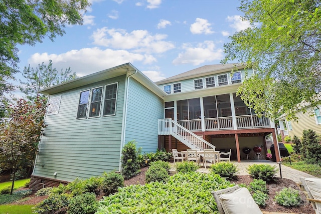 5424 Morris Hunt Dr, Fort Mill, SC 29708 - back of house with a patio, a sunroom, stairway, and concrete driveway