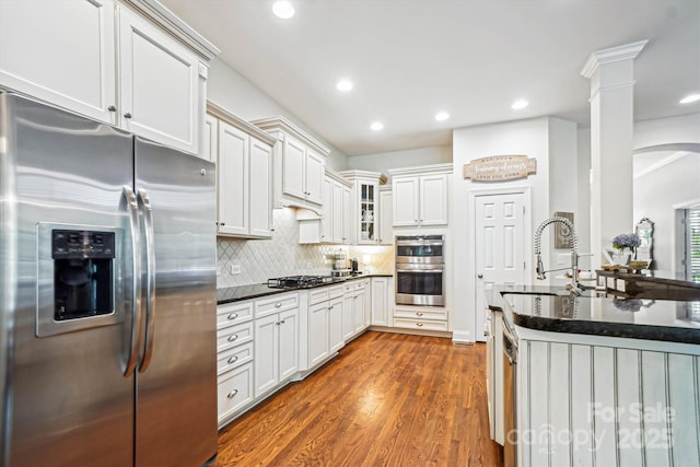 5424 Morris Hunt Dr, Fort Mill, SC 29708 - kitchen with appliances with stainless steel finishes, glass insert cabinets, dark wood-type flooring, tasteful backsplash, and recessed lighting