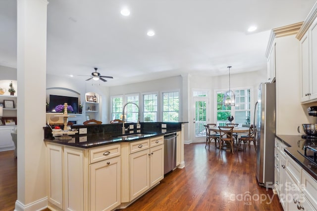 5424 Morris Hunt Dr, Fort Mill, SC 29708 - kitchen with stainless steel appliances, a sink, cream cabinetry, dark wood-type flooring, and a ceiling fan
