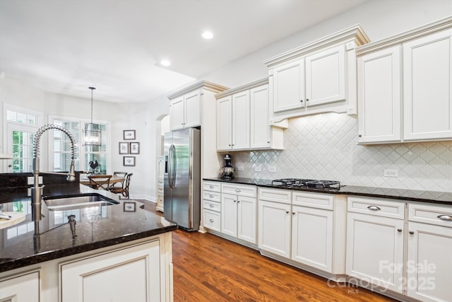 5424 Morris Hunt Dr, Fort Mill, SC 29708 - kitchen with stainless steel refrigerator with ice dispenser, gas cooktop, arched walkways, a sink, and dark wood-style floors