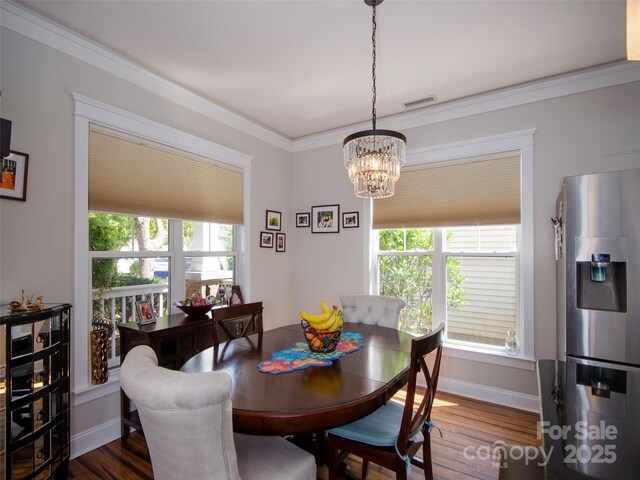 1410 Kenton Ln, Asheville, NC 28803 - dining space with a chandelier, healthy amount of natural light, dark wood finished floors, baseboards, and ornamental molding