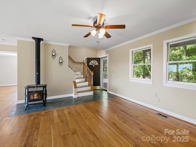 58 Randall Dr, Fairview, NC 28730 - unfurnished living room with hardwood / wood-style flooring, crown molding, stairs, ceiling fan, and baseboards
