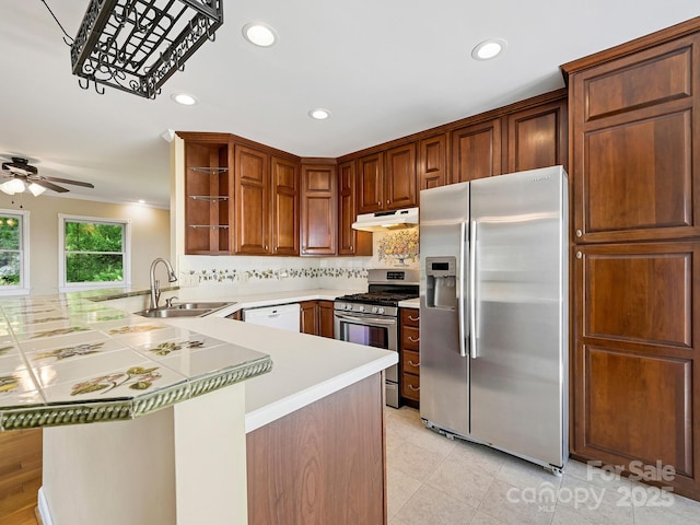 58 Randall Dr, Fairview, NC 28730 - kitchen with appliances with stainless steel finishes, a peninsula, a sink, under cabinet range hood, and recessed lighting