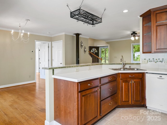 58 Randall Dr, Fairview, NC 28730 - kitchen with white dishwasher, a sink, a peninsula, ornamental molding, and light countertops