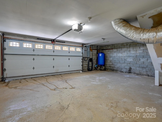 58 Randall Dr, Fairview, NC 28730 - garage featuring a garage door opener, electric panel, and concrete block wall