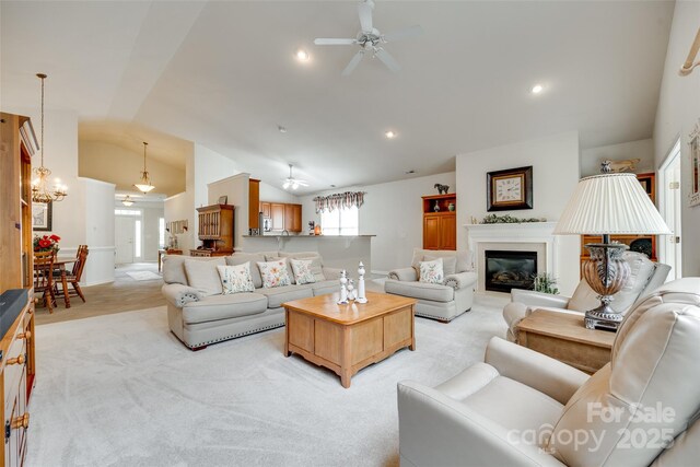539 Turquoise Way, Fort Mill, SC 29708 - living room with a ceiling fan, vaulted ceiling, light carpet, a glass covered fireplace, and recessed lighting