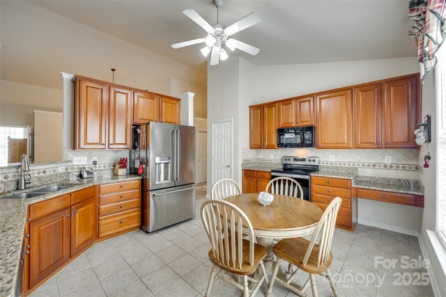 539 Turquoise Way, Fort Mill, SC 29708 - kitchen with appliances with stainless steel finishes, a sink, vaulted ceiling, light tile patterned floors, and tasteful backsplash