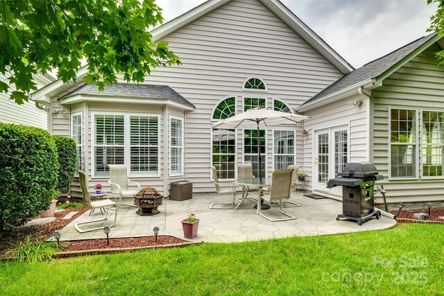 539 Turquoise Way, Fort Mill, SC 29708 - back of house featuring a fire pit, a patio, and a lawn