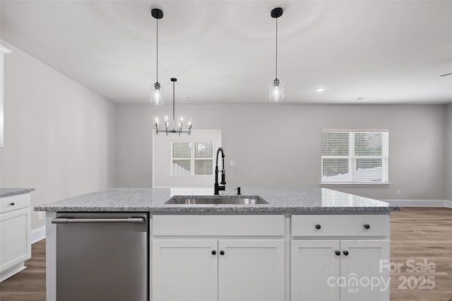 6712 W Sugar Creek Rd, Charlotte, NC 28269 - kitchen featuring stainless steel dishwasher, a sink, white cabinetry, wood finished floors, and baseboards