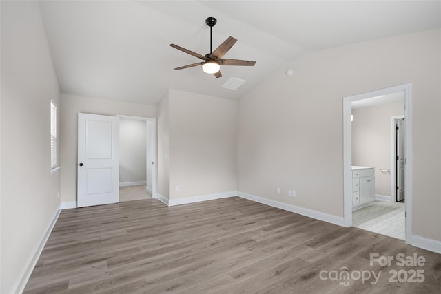 6712 W Sugar Creek Rd, Charlotte, NC 28269 - unfurnished bedroom with vaulted ceiling, light wood-style flooring, connected bathroom, baseboards, and a ceiling fan