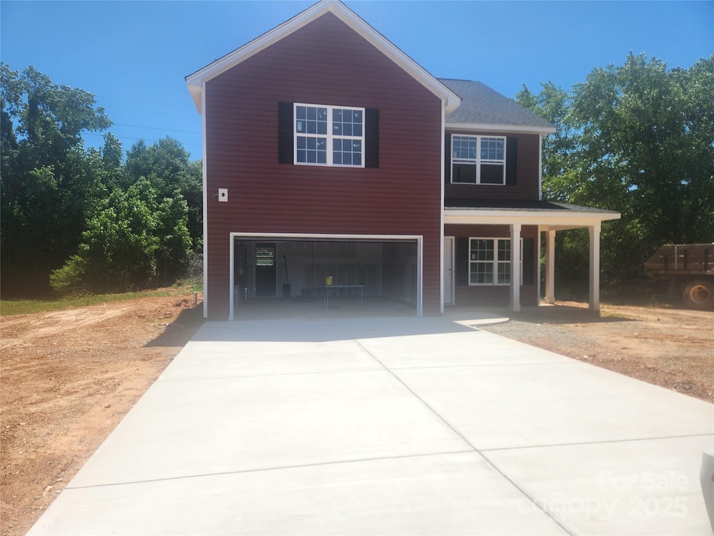 2300 Grayson Pkwy, Monroe, NC 28110 - view of front facade featuring driveway, an attached garage, and covered porch