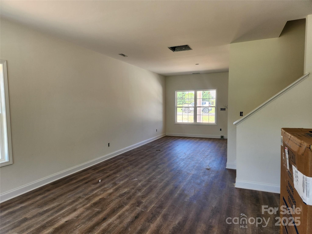 2300 Grayson Pkwy, Monroe, NC 28110 - unfurnished living room with dark wood-style flooring and baseboards