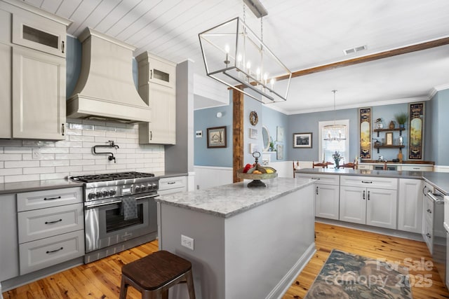 420 S Cedar St, Lincolnton, NC 28092 - kitchen featuring high end stainless steel range, custom exhaust hood, a chandelier, a center island, and crown molding