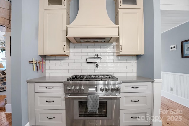 420 S Cedar St, Lincolnton, NC 28092 - kitchen with high end range, premium range hood, wood finished floors, glass insert cabinets, and wainscoting