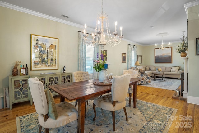 420 S Cedar St, Lincolnton, NC 28092 - dining space with a chandelier, ornamental molding, light wood-style flooring, and baseboards