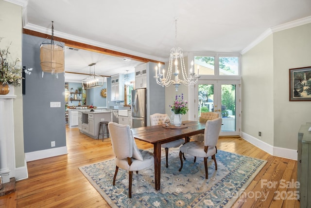 420 S Cedar St, Lincolnton, NC 28092 - dining room with a chandelier, baseboards, light wood-type flooring, and ornamental molding