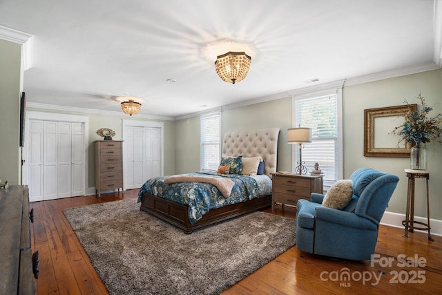 420 S Cedar St, Lincolnton, NC 28092 - bedroom with wood-type flooring, two closets, ornamental molding, and baseboards