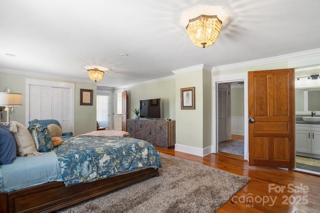420 S Cedar St, Lincolnton, NC 28092 - bedroom with a sink, wood finished floors, a chandelier, crown molding, and a closet