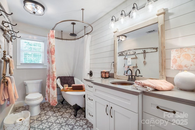 420 S Cedar St, Lincolnton, NC 28092 - full bath with vanity, toilet, wood walls, tile patterned floors, and a combined bath / shower with rainfall shower