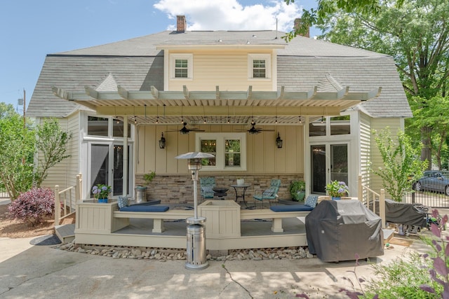 420 S Cedar St, Lincolnton, NC 28092 - back of property featuring a deck, a pergola, a ceiling fan, stone siding, and board and batten siding