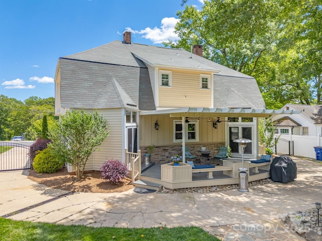 420 S Cedar St, Lincolnton, NC 28092 - rear view of house with a gate, a gambrel roof, and a chimney