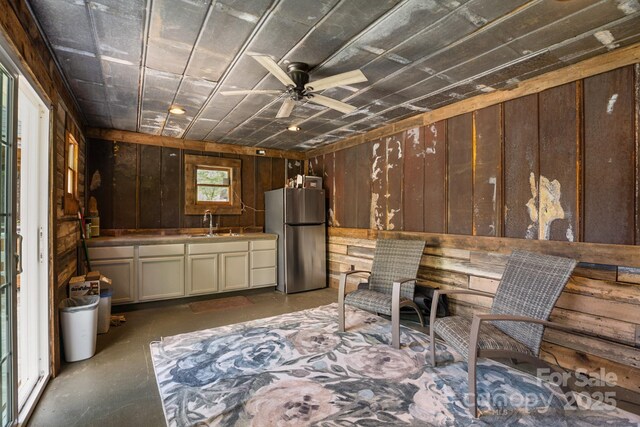 420 S Cedar St, Lincolnton, NC 28092 - miscellaneous room featuring a sink, concrete floors, wooden walls, and ceiling fan