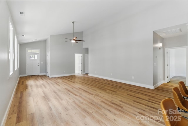 192 Plato Pl, Etowah, NC 28729 - unfurnished living room featuring light wood finished floors, lofted ceiling, ceiling fan, and baseboards