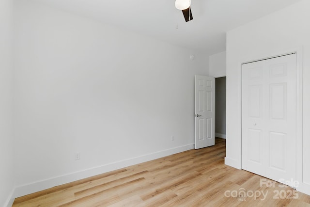 192 Plato Pl, Etowah, NC 28729 - unfurnished bedroom with wood finished floors, baseboards, and a ceiling fan
