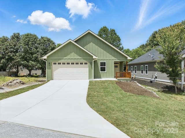 192 Plato Pl, Etowah, NC 28729 - ranch-style house with board and batten siding, a garage, driveway, and a front lawn