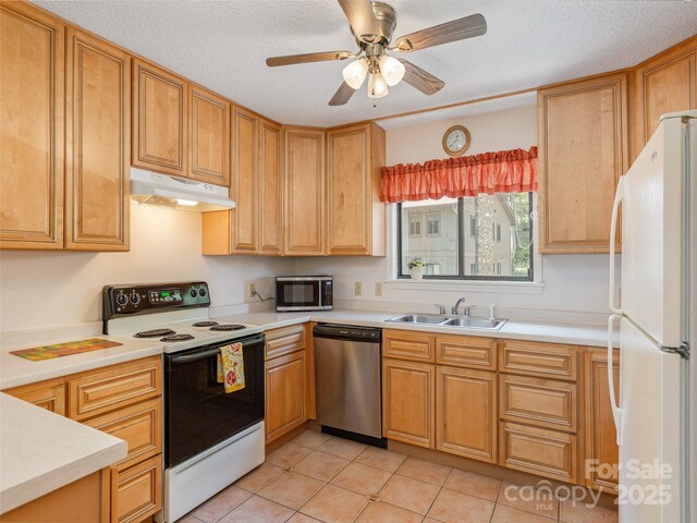 55 Lake Dr Unit 4P, Laurel Park, NC 28739 - kitchen featuring stainless steel appliances, a sink, under cabinet range hood, light countertops, and a textured ceiling