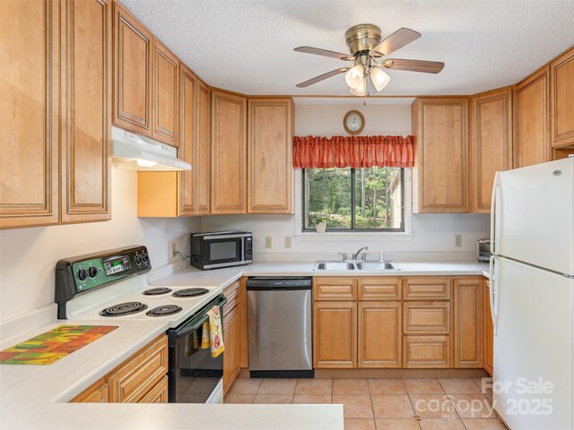 55 Lake Dr Unit 4P, Laurel Park, NC 28739 - kitchen with stainless steel dishwasher, freestanding refrigerator, electric range, a sink, and under cabinet range hood