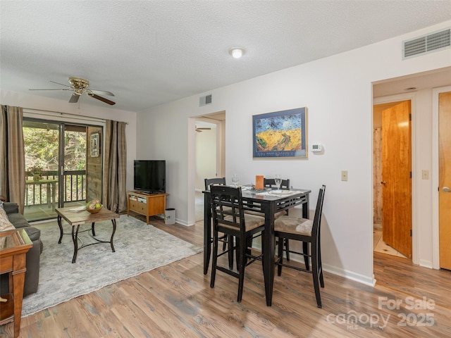 55 Lake Dr Unit 4P, Laurel Park, NC 28739 - dining area featuring ceiling fan, wood finished floors, a textured ceiling, and baseboards