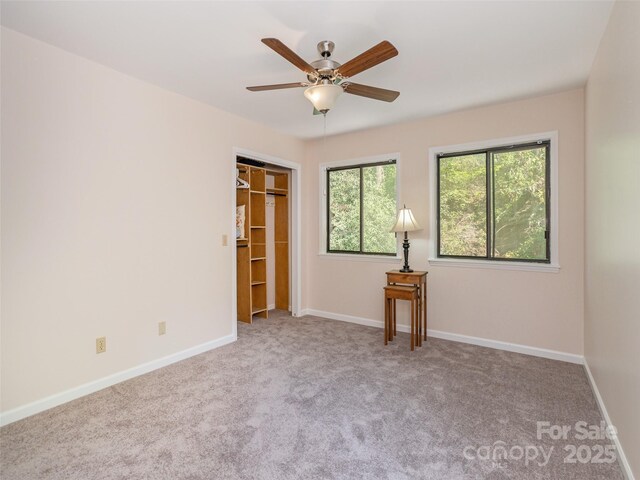 55 Lake Dr Unit 4P, Laurel Park, NC 28739 - unfurnished bedroom with carpet floors, baseboards, a closet, and a ceiling fan