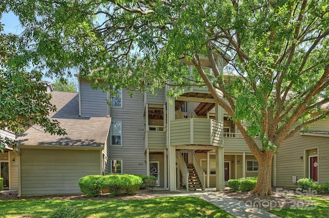 2533 Stockbridge Dr, Charlotte, NC 28210 - rear view of house featuring stairway, a shingled roof, and a yard