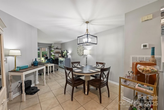 2533 Stockbridge Dr, Charlotte, NC 28210 - dining area with light tile patterned flooring, a chandelier, and baseboards